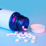 blue-white-label-medication-bottle-with-loose-pills-mockup